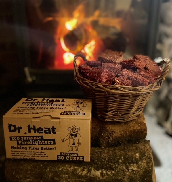 Box of dr heat natural firelighters in front of an open fire woodfuel cooperative